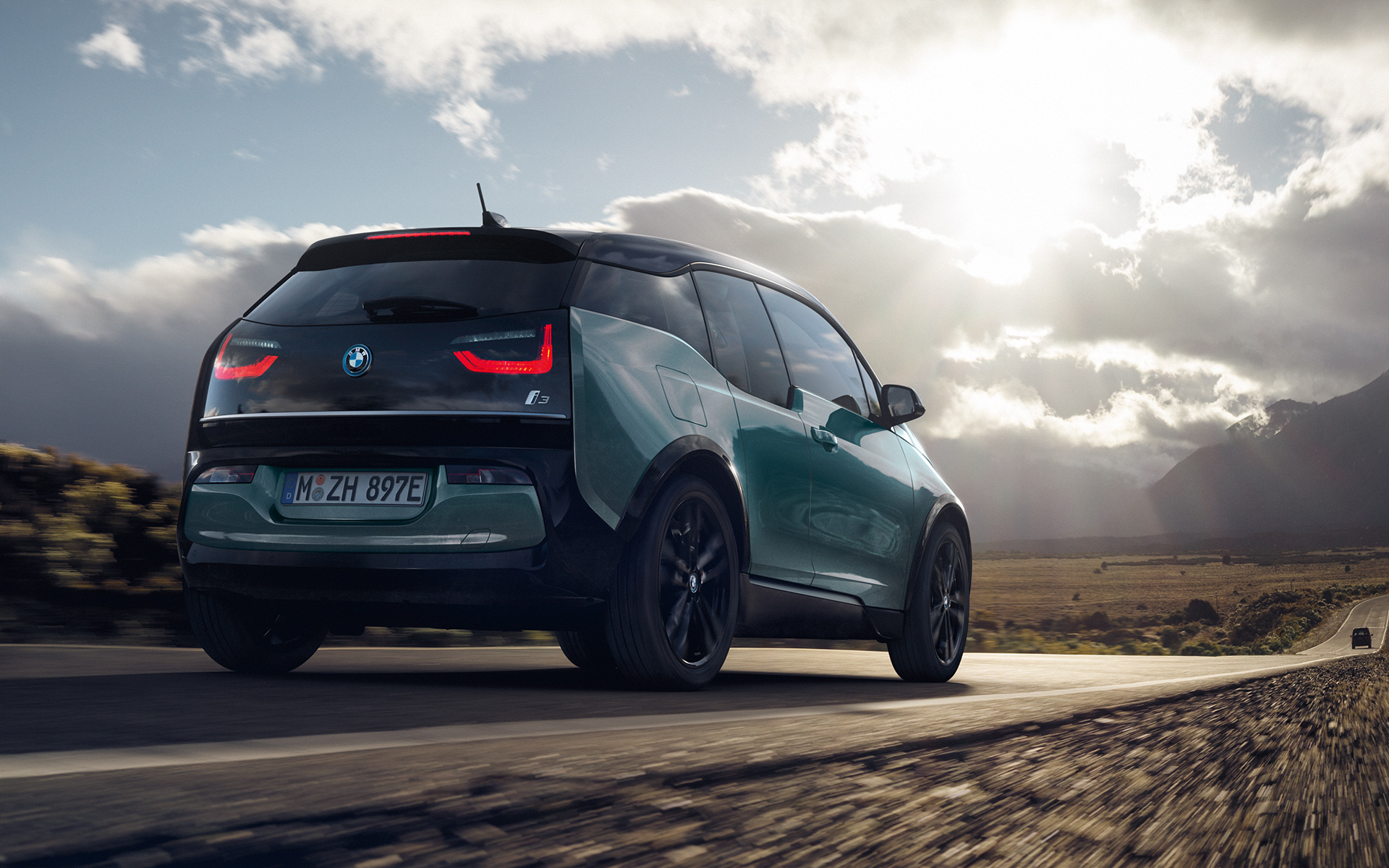 BMW i3 I01 2018 Blue Ridge Mountain sa Frozen Grey metalik karakteristikama tročetvrtinski pogled straga u vožnji autocestom