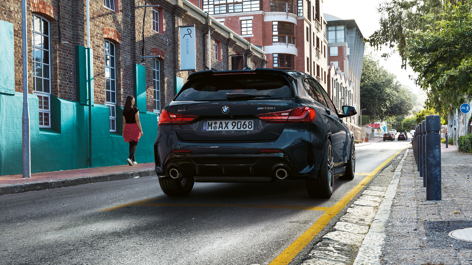 BMW M135i xDrive, prikaz stražnjeg kraja. BMW M135i xDrive u Black Sapphire metalik boji, prikaz stražnjeg kraja prilikom parkiranja.